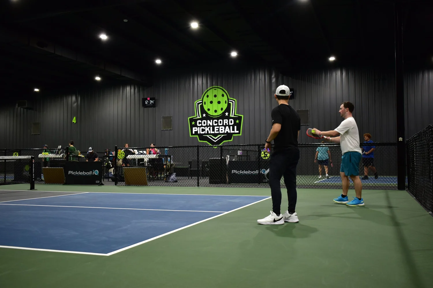 Indoor courts and player seating at Concord Pickleball