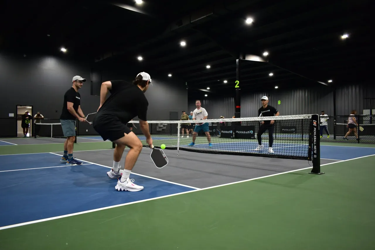 A fast rally on the indoor courts at Concord Pickleball