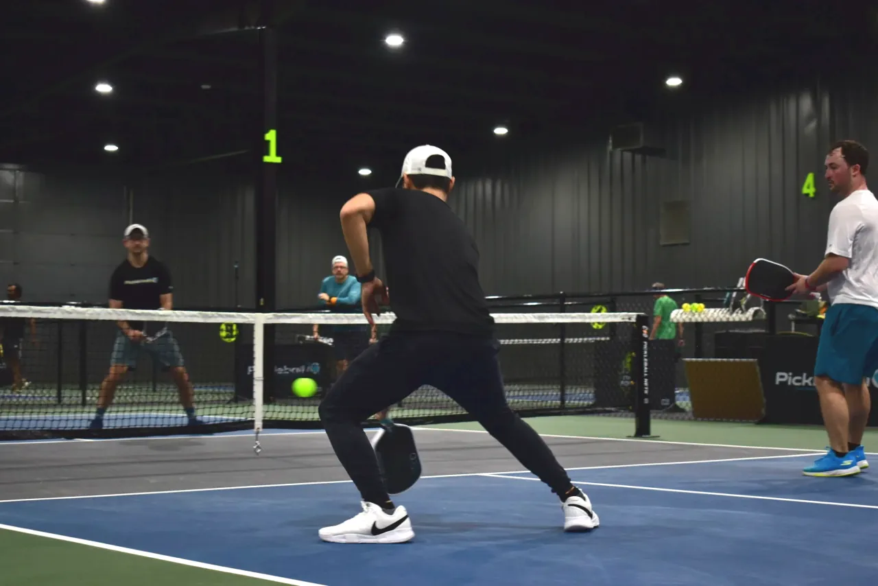 Players working through a point on a Concord Pickleball court